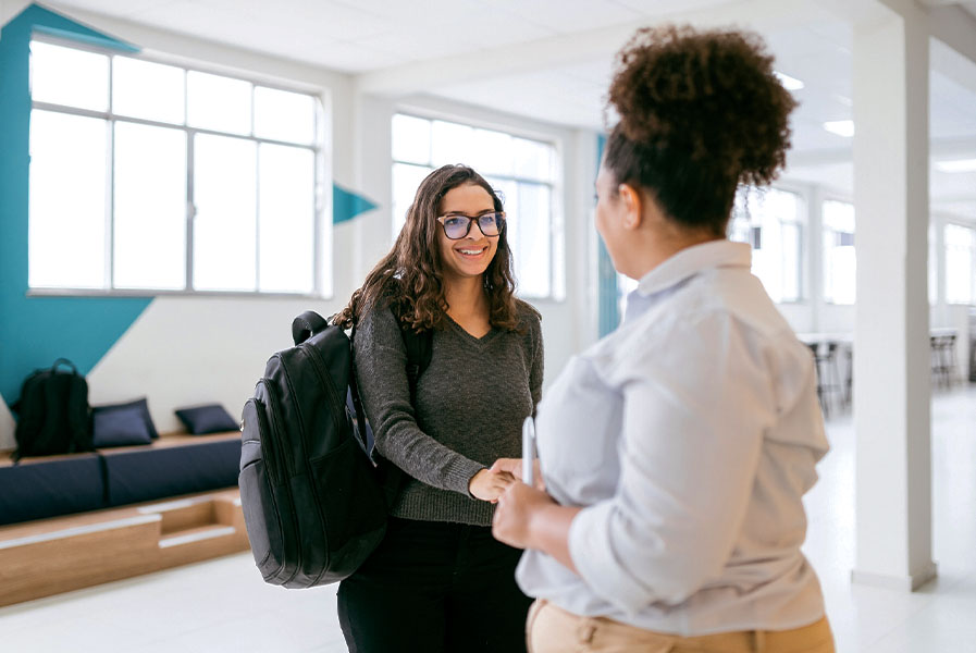 A student shaking hands with her mentor